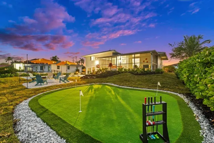 Outdoor Oasis: Perfect your putt in the lush yard, surrounded by stunning sunset views!