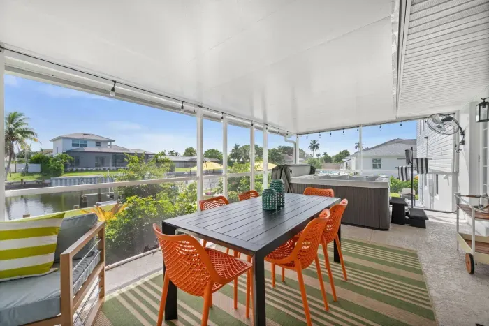 Enjoy alfresco meals overlooking serene waters in vibrant seating!