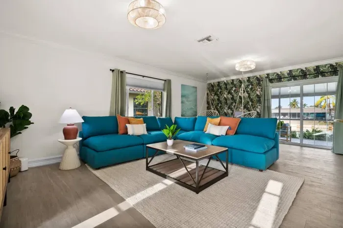 Living Room: Vibrant hues and tropical decor create the perfect retreat for relaxation and fun!