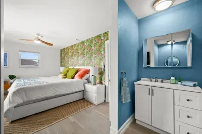 Charming Bedroom Retreat: Bright colors, tropical vibes, and an en-suite for your island getaway!