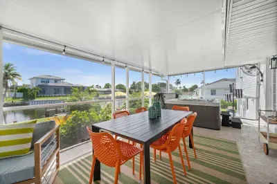 Enjoy alfresco meals overlooking serene waters in vibrant seating!