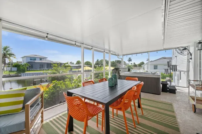 Enjoy alfresco meals overlooking serene waters in vibrant seating!