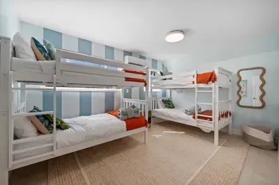 Bunk Room Delight: Fun bunk beds and bright decor create the perfect kids’ retreat!