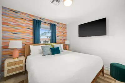 Vibrant Bedroom Retreat: Enjoy serene views and playful decor in this stylish escape!
