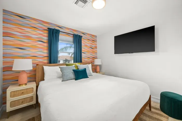 Vibrant Bedroom Retreat: Enjoy serene views and playful decor in this stylish escape!