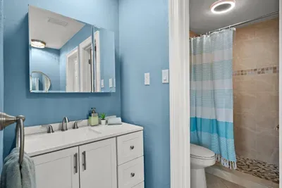 Bathroom Bliss: Bright blue walls and modern fixtures for a refreshing retreat after beach days!