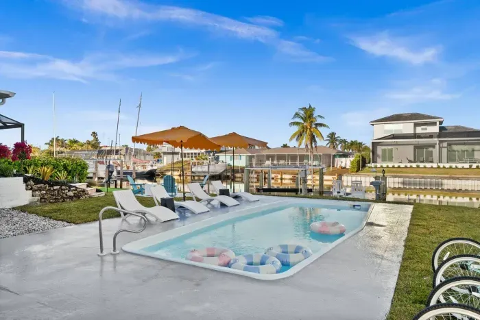 Outdoor Oasis: Dive into relaxation by the pool with stunning waterfront views and vibrant sunsets!