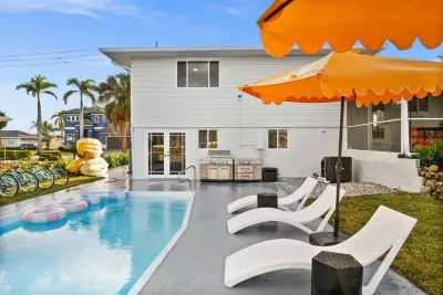 Outdoor Paradise: Relax by the pool with vibrant seating and fun water toys in sunny Marco Island!