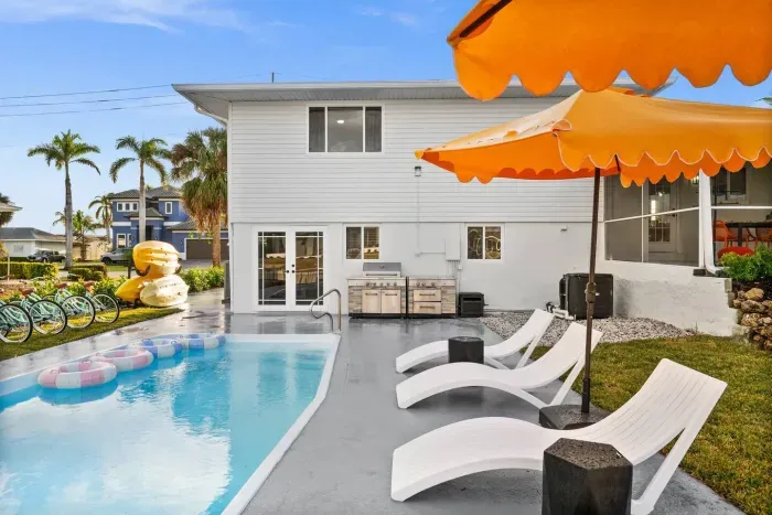 Outdoor Paradise: Relax by the pool with vibrant seating and fun water toys in sunny Marco Island!