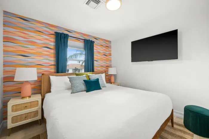 Vibrant Bedroom Retreat: Enjoy serene views and playful decor in this stylish escape!