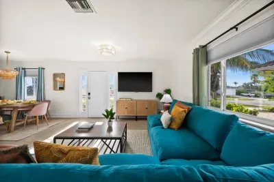 Living Room: Bright and airy retreat with vibrant furniture and views of palm trees. Perfect for relaxation!
