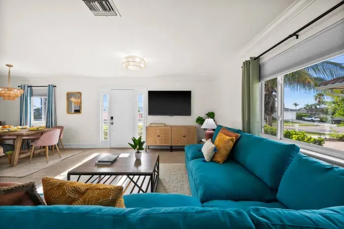 Living Room: Bright and airy retreat with vibrant furniture and views of palm trees. Perfect for relaxation!