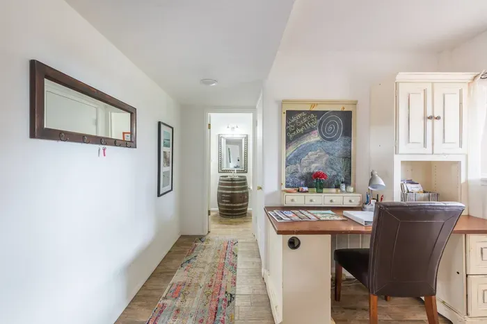 Hallway to bathroom. A welcome message greets you on the chalkboard.