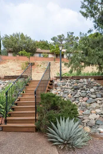 Steps up to the main street with private parking area