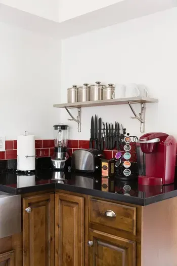 Fully stocked kitchen with knives, blender, and Keurig coffee maker