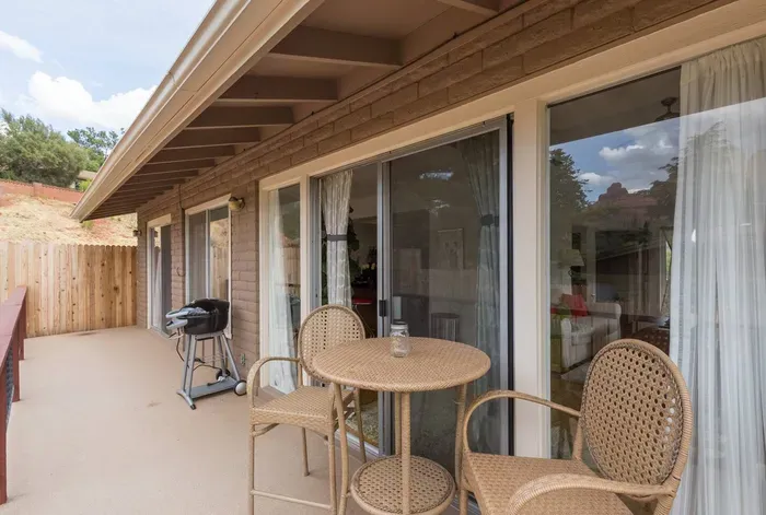 Backyard patio with electric grill and seating/ dining area