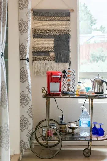 Complimentary coffee & tea cart includes Keurig coffee maker with pods, tea cups, and water bottle.