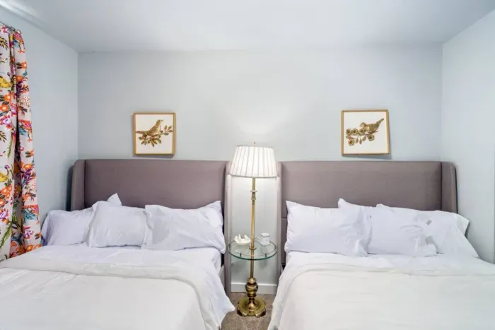 Two full size beds, Serta pillow-top mattresses, night stand with lamp, charging cable for phones, jewelry dish, blackout curtains, 2 luggage racks