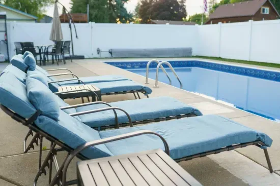 Patio furniture: Four pool lounge chairs with adjustable backs for sunbathing, small end tables for drinks, out-door dinning table and chairs for 6 and collapsible umbrella, large umbrellas for shade