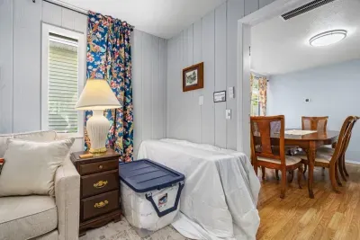 Cozy nook with cheerful decor beside a bright dining area