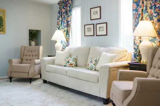 Pull-out couch with queen size mattress, wing-back recliners, arm chairs, 55" Smart TV, ceiling fan