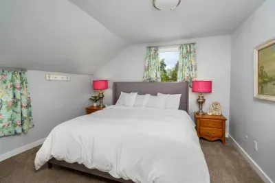 King size bed, DreamCloud premium memory foam mattress, two night stands with storage, two lamps, charging cable for phones, jewelry dish, room darkening curtains, 2 luggage racks, box fan, 2 bathrobes for pool area, laundry hamper, shower cady