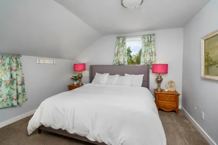 King size bed, DreamCloud premium memory foam mattress, two night stands with storage, two lamps, charging cable for phones, jewelry dish, room darkening curtains, 2 luggage racks, box fan, 2 bathrobes for pool area, laundry hamper, shower cady