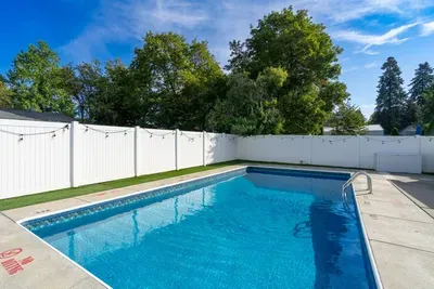 Private backyard pool with sunny deck, privacy fence, and relaxing ambiance