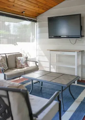 Outdoor loveseat and two chairs, coffee table, 46" TV, entertainment cart, electric candles, ceiling fan