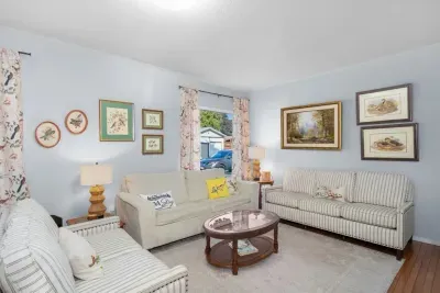 Bright, cozy living room with ample seating and charming decor