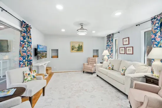 Pull-out couch with queen size mattress, two wing-back recliners, two arm chairs, 55" Smart TV, ceiling fan
