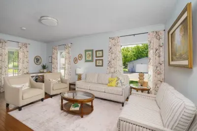 Couch, loveseat, arm chairs, electric fireplace entertainment center, lamps, living room tables, and basket of fleece throw blankets. 60" TV offer online streaming. 