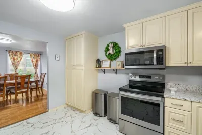 Bright updated kitchen with stainless appliances and adjacent dining area
