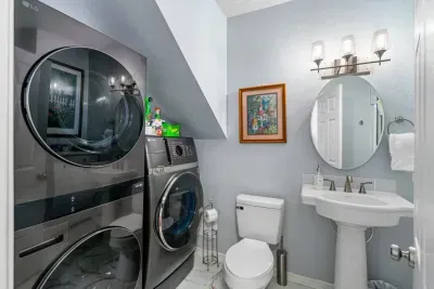 Bright bathroom with in-unit washer/dryer for added guest convenience