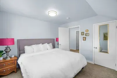 Bright, cozy bedroom with plush king bed and crisp white linens