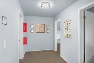 Bright, welcoming hallway with charming decor and easy room access