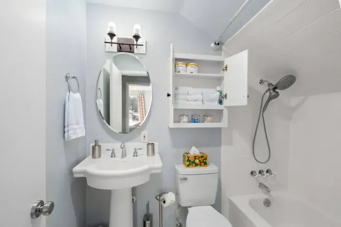 Upstairs bath: Shower-tub combination, soap bars, PooPourri spray, Neutrogena individually packaged makeup remover towelettes, cotton balls, Q-tips, shampoo, conditioner and body wash