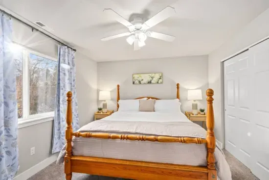 BEDROOM 1: King size bed, nightstands with storage, dresser, lamps, room-darkening curtains, phone charging cable, luggage rack, ceiling fan, clothes hangers, laundry hamper.
