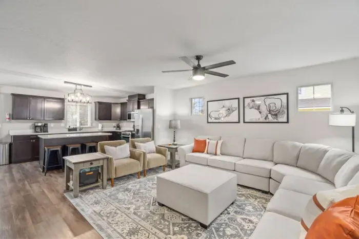 LIVING / DINING: Relax on the comfy couch in the living room with a cozy gas fireplace and a 64" smart TV for streaming your favorite shows and movies. Enjoy a meal at the dining table seating 8, with additional space at the kitchen island for 4.