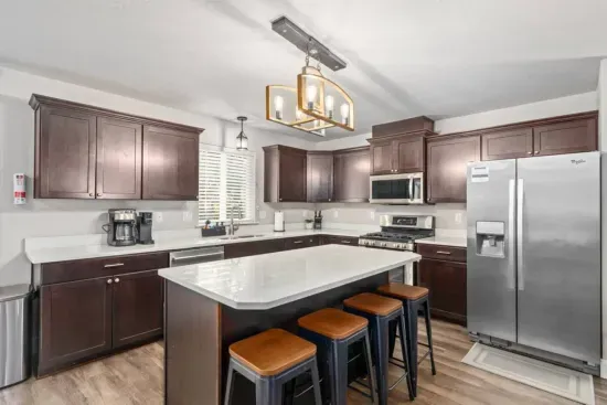 Enjoy a meal at the dining table seating 8, with additional space at the kitchen island for 4.
