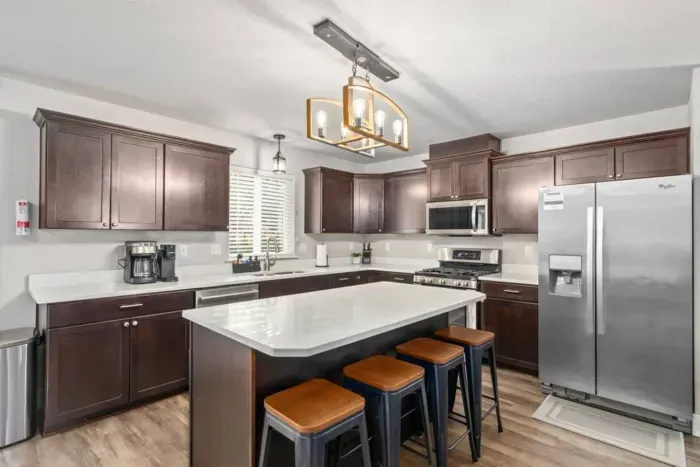 Enjoy a meal at the dining table seating 8, with additional space at the kitchen island for 4.