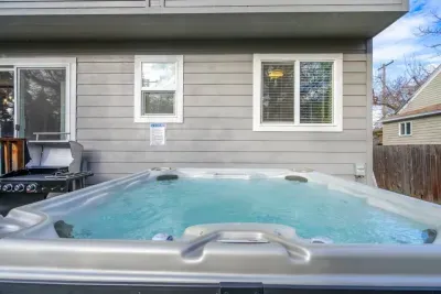 OUTDOOR: Unwind in the 7-person hot tub or BBQ with the supplied grill and utensils.