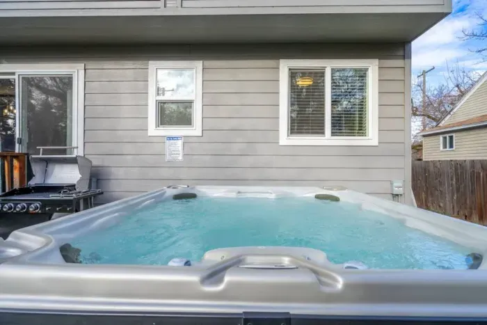 OUTDOOR: Unwind in the 7-person hot tub or BBQ with the supplied grill and utensils.