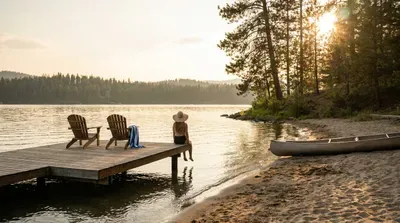 Enjoy a peaceful lakeside sunset with a canoe