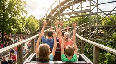 People on a wooden roller coaster at an amusement park