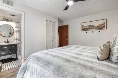 Main floor primary bedroom with King bed and private full bathroom with walk-in shower.