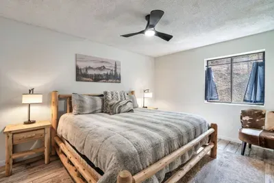 Main floor primary bedroom with King bed and private full bathroom with walk-in shower.