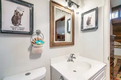 Upstairs bathroom with tub and shower for second bedroom.