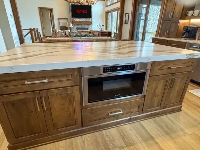 An oversized kitchen island featuring a luxurious Bosch drawer microwave.