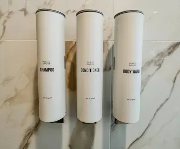 All the necessary amenities – shampoo, conditioner, and body wash – for a luxurious experience.